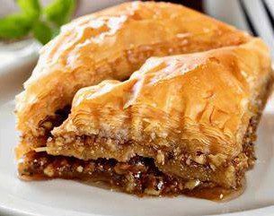 Layers of flaky phyllo pastry filled with rich walnuts and aromatic cinnamon, drizzled with golden honey syrup for a sweet finish.